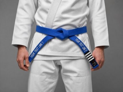 Blue personalized BJJ belt with embroidery and rank stripes worn over a white gi