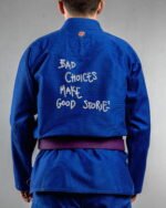 Bad Choices Make Good Stories embroidery on the back of a blue BJJ Gi