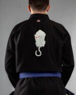Caged embroidery on the back of a black BJJ Gi