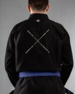 Discomfort Now Comfort Later embroidery on the back of a black BJJ Gi