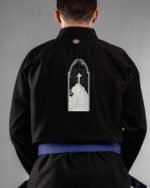Cross embroidery on the back of a black BJJ Gi