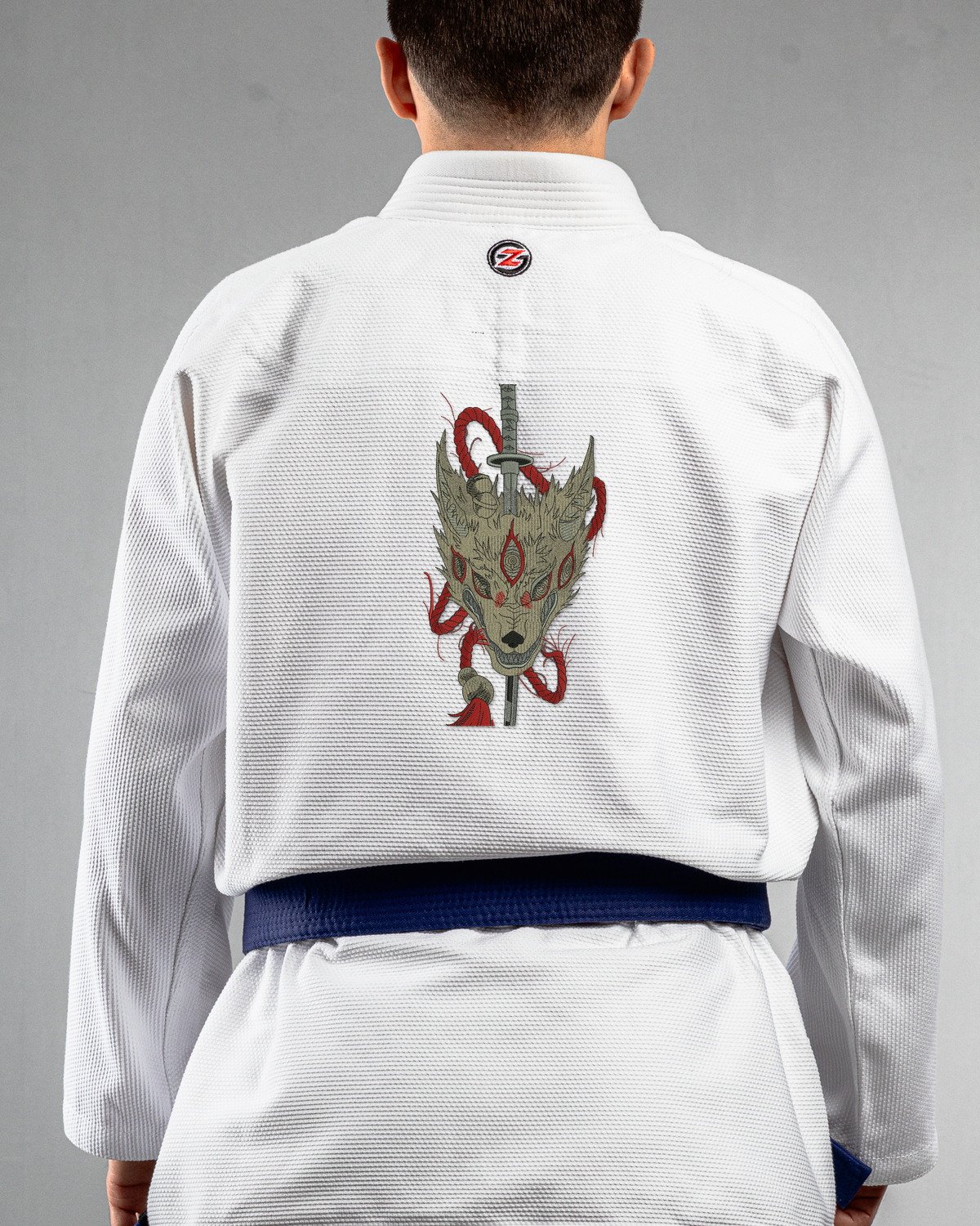 Cursed Howl white Gi back mockup Cursed Howl embroidery on the back of a white BJJ Gi