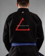 Disappear & Do Better embroidery on the back of a black BJJ Gi