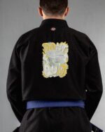 Dont Quite embroidery on the back of a black BJJ Gi