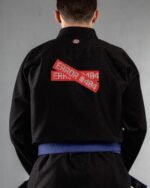 Error embroidery on the back of a black BJJ Gi