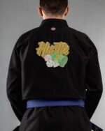 Hustle embroidery on the back of a black BJJ Gi