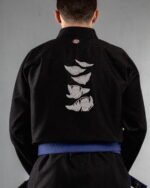 Monster Mouth embroidery on the back of a black BJJ Gi
