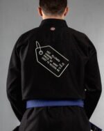 Not Allowed To Change The Price embroidery on the back of a black BJJ Gi