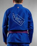 Not Allowed To Change The Price embroidery on the back of a blue BJJ Gi