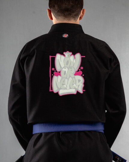 Now Or Never embroidery on the back of a black BJJ Gi