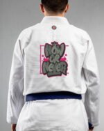 Now Or Never embroidery on the back of a white BJJ Gi