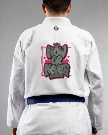Now Or Never embroidery on the back of a white BJJ Gi