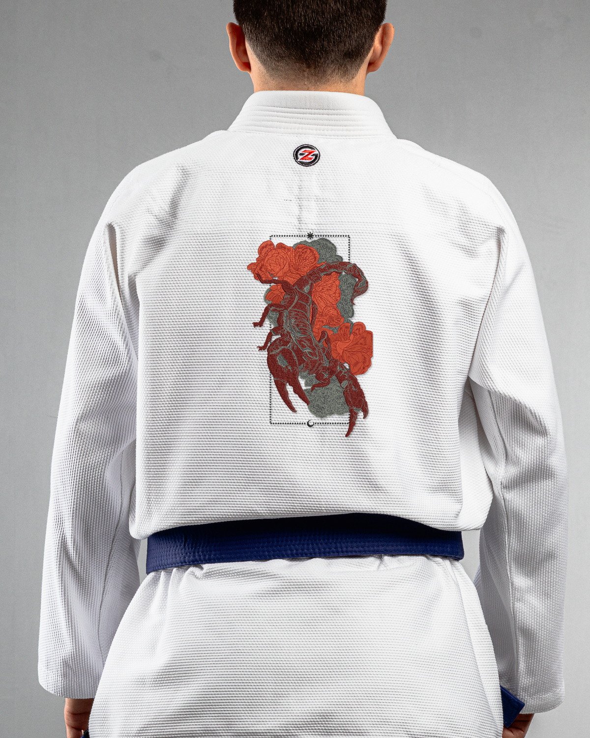 Scorpion white Gi back mockup Scorpion embroidery on the back of a white BJJ Gi