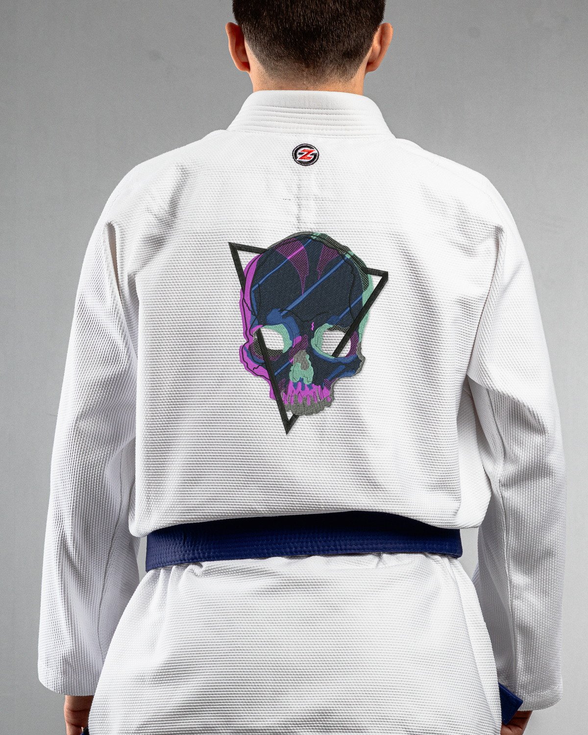 Skull Glitch white Gi back mockup Skull Glitch embroidery on the back of a white BJJ Gi