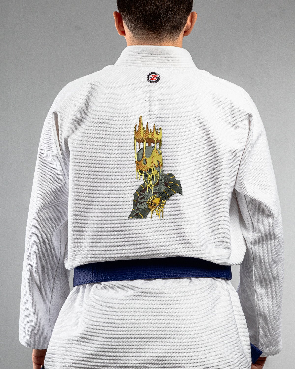 Golden King white Gi back mockup Golden King embroidery on the back of a white BJJ Gi