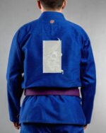 Skull With A Broken Horn embroidery on the back of a blue BJJ Gi