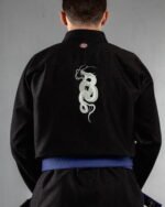 Snake Fangs embroidery on the back of a black BJJ Gi