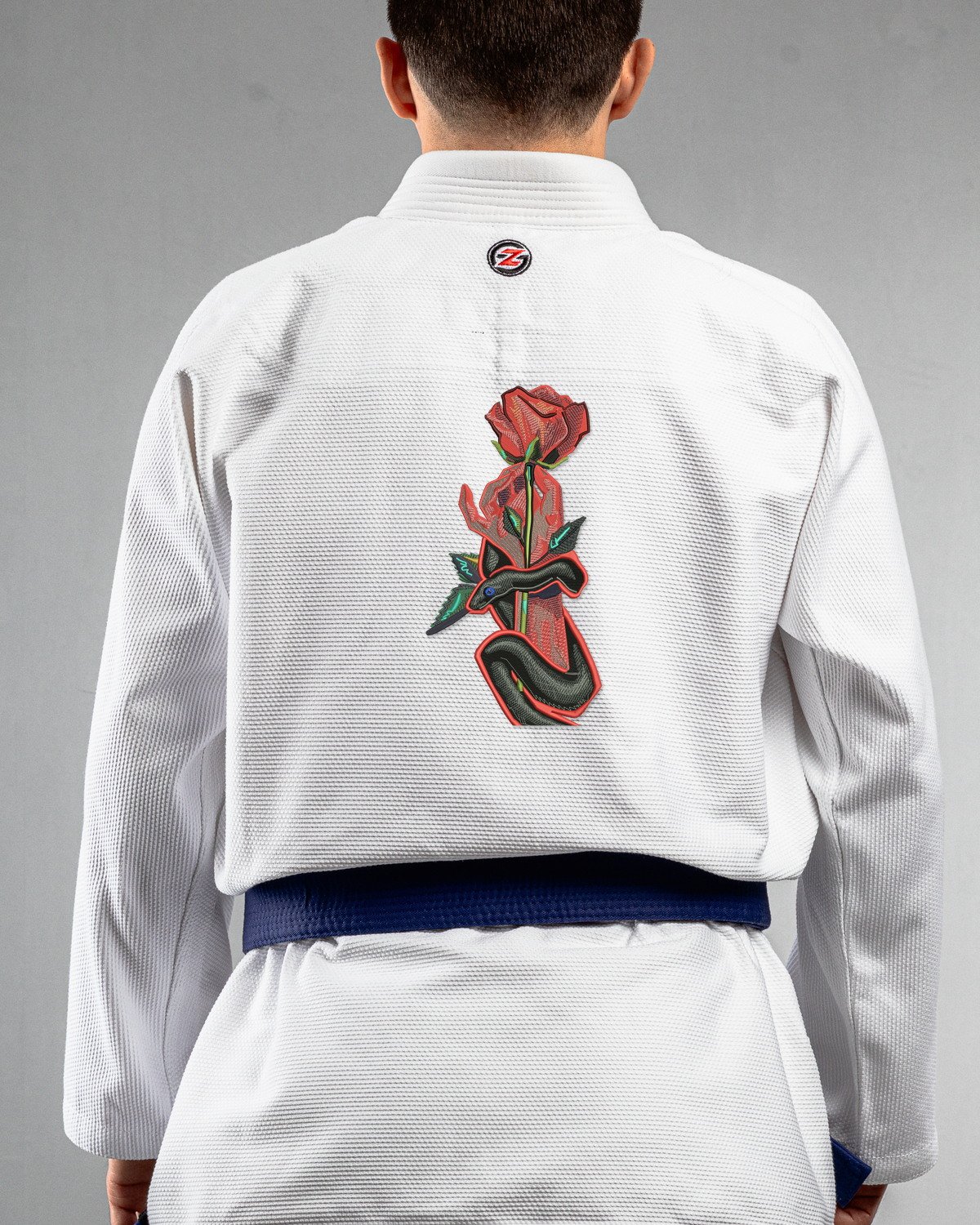 Snake & Rose white Gi back mockup Snake & Rose embroidery on the back of a white BJJ Gi