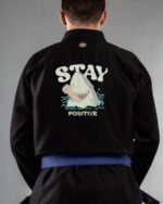 Stay Positive embroidery on the back of a black BJJ Gi
