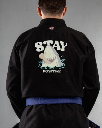 Stay Positive embroidery on the back of a black BJJ Gi