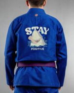 Stay Positive embroidery on the back of a blue BJJ Gi