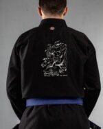Swimming With The Sharks embroidery on the back of a black BJJ Gi