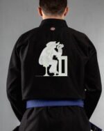 Tainted Care embroidery on the back of a black BJJ Gi