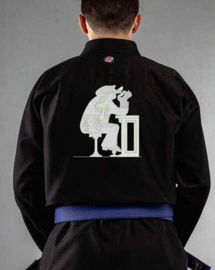 Tainted Care embroidery on the back of a black BJJ Gi