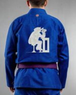 Tainted Care embroidery on the back of a blue BJJ Gi