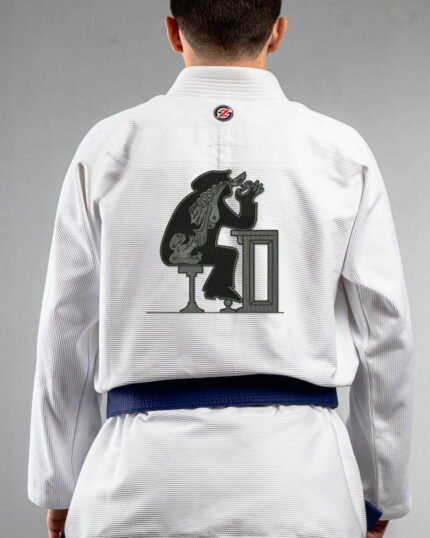 Tainted Care embroidery on the back of a white BJJ Gi